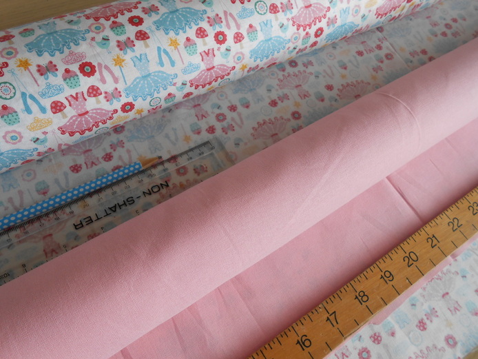Rolls of fabirc, ballerina fabirc, plain pink fbairc, ruller, pencil, sewing